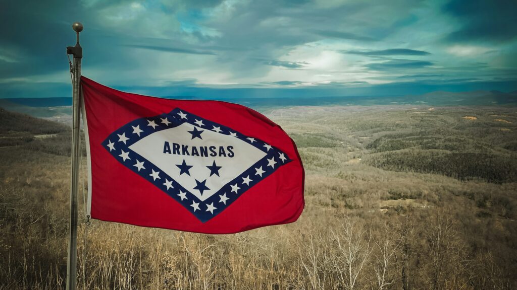 The Arkansas state flag waving in the wind.