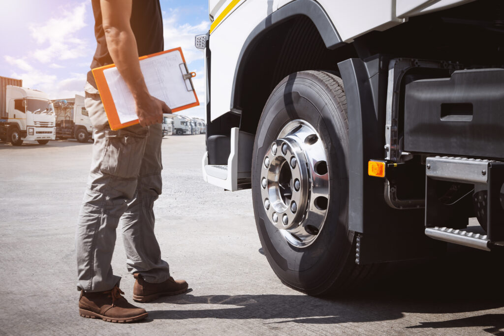 Truck Drivers Holding Clipboard to Check Truck Tires. Semi Truck Tractor, Big rig. Maintenance Safety Checklist, Inspecting Safety Driving. Freight Logistics Truck Transportation.